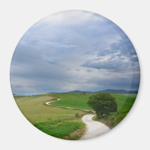 Curvy road towards a destination round magnet