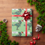 Custom Name Dinosaur Merry Christmas Lights Kids Wrapping Paper<br><div class="desc">Make their Christmas presents even more special with this personalised gift wrap,  featuring a cartoon T-Rex wearing a Santa hat and tangled up in Christmas lights on a light green background. A cartoon speech bubble contains the words "Merry Christmas" and your child's name.</div>