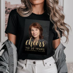 Custom Photo Cheers 50th Birthday Party T-Shirt<br><div class="desc">This 50th birthday party t-shirt features the guest of honour's photo with a gold-coloured text overlay. The word "cheers" appears in elegant gold-coloured calligraphy script, followed by "to 50 years" and the guest of honour's name and birthday in sans serif font. A dark screen helps make the text pop. A...</div>