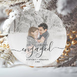 Custom Photo First Christmas Engaged Grey Script Ornament<br><div class="desc">Commemorate your engagement with this beautiful modern keepsake ornament. The grey text reads "Our first Christmas engaged, " with the word "engaged" in elegant handwriting script with flourishes before and after. Replace the sample image with your favourite photo, and add your names and the year. A white gradient filter helps...</div>