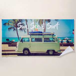 Custom, vintage beach camper bus and palm trees: towel
