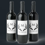 Customisable White And Black Deer Antler Monogram  Wine Label<br><div class="desc">Design Concept: The design features intricately detailed deer antlers in a combination of white and black hues, creating a striking contrast that highlights the natural beauty of these majestic symbols. The antlers are arranged in a symmetrical and balanced manner, framing the central monogram. Monogram: The monogram itself is customisable, typically...</div>