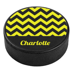 Customizable yellow and black chevron pattern hockey puck