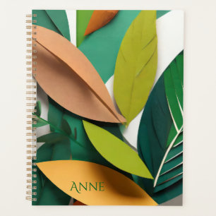 Cut paper leaves in green and gold planner