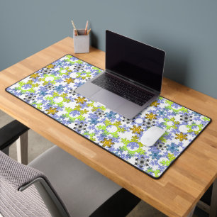 Cut paper snowflakes multicolored on white desk mat