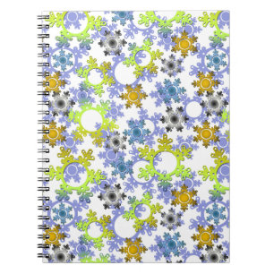Cut paper snowflakes multicolored on white notebook