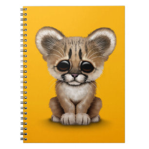 Cute Baby Cougar Cub on Yellow Notebook