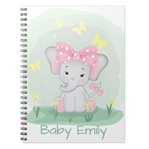 Cute baby elephant with a pink bow in a clearing  Notebook