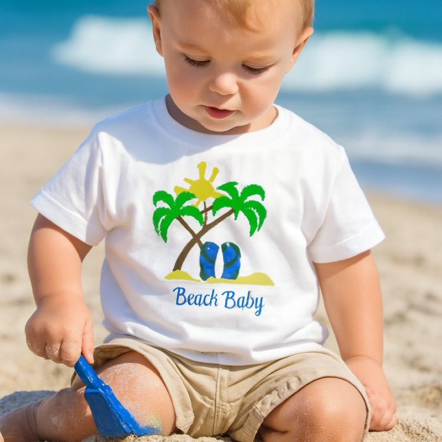 Cute Beach Baby  T-Shirt (a toddler playing in the sand with a small blue shovel, wearing a white crewneck short-sleeve tee-)