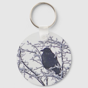 Cute black bird in snowy branches key ring