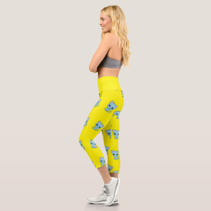 Cute bouncy blue kitten on yellow capri leggings