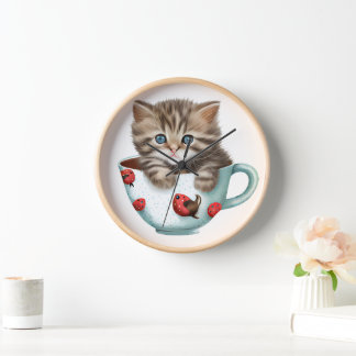 CUTE BROWN TABBY KITTEN SITTING IN A TEACUP CLOCK
