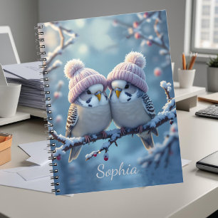 Cute budgies with bobble hats on a branch notebook