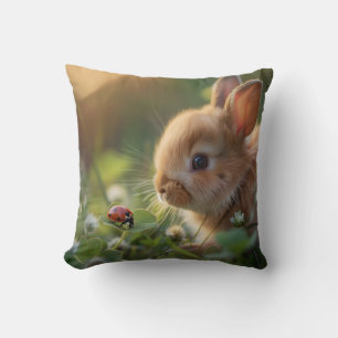 Cute bunny rabbit and a ladybug on the green field cushion