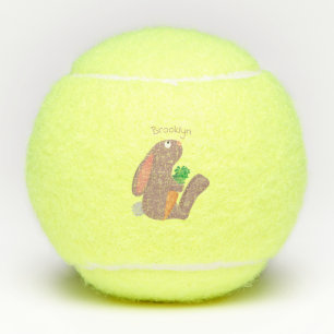 Cute bunny rabbit sitting with carrot cartoon tennis balls