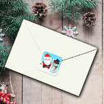 Cute cartoon father christmas with a snowman square sticker<br><div class="desc">Sweet Christmas stickers depicting a cartoon santa and a cartoon snowman. The little santa has his traditional red suit and hat both with a white fur trim.He is wearing green mittens and a black belt and black shiny boots. He has big blue eyes and rosey cheeks, probably from the cold...</div>