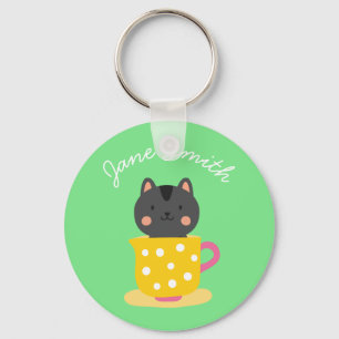 Cute cat in teacup cartoon on mint key ring