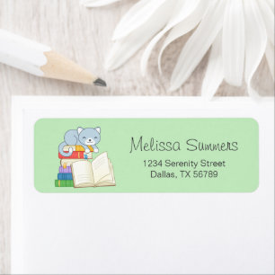 Cute Cat on top of a Book Stack on Green