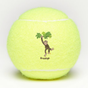 Cute chimpanzee in jungle hanging cartoon tennis balls