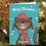 Cute Christmas Cat Cartoon  Card<br><div class="desc">This festive Christmas greeting card has an adorable cat wearing a winter hat and scarf, with snowflakes in the background. This card is the best way to convey a message of holidays joy to your loved ones and is certain to put a smile on anyone's face. Personalise it with your...</div>