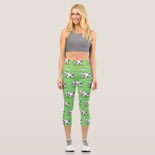 Cute cow in green field cartoon illustration capri leggings