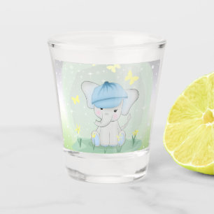 Cute elephant in a flower meadow. shot glass