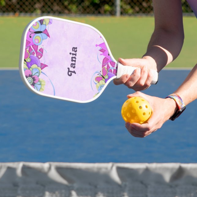 Cute flowers and butterflies on purple pickleball paddle (Insitu)