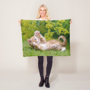 Cute funny cat kitten playing in a flowery garden fleece blanket