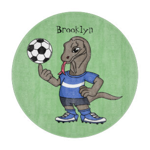 Cute funny Komodo dragon playing soccer cartoon  Cutting Board