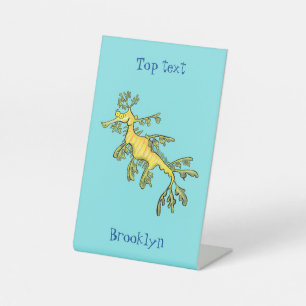 Cute funny leafy sea dragon cartoon illustration pedestal sign