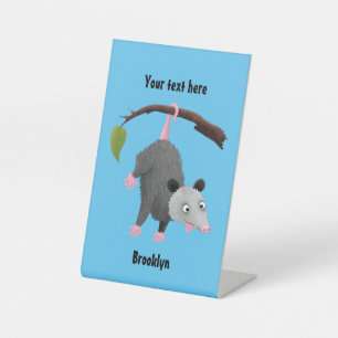 Cute funny opossum hanging from branch cartoon  pedestal sign