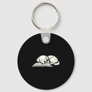 Cute golden retriever dog sleeping on book reader key ring