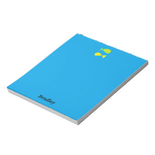 Cute green and yellow fishes on blue notepad