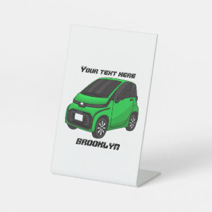 Cute green micro sized car  pedestal sign
