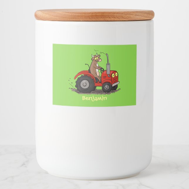Cute happy cow driving a red tractor cartoon food label (Front)