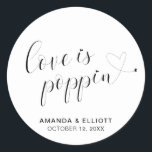 Cute Heart Popcorn Favours Modern Wedding Classic Round Sticker<br><div class="desc">Typography wedding favour stickers featuring the message, "Love Is Poppin" in black calligraphy with a heart dotting the "i's" and a swash at the end and your names and date below, over a white background. The simple and minimal layout and lots of open space give this design a modern feel...</div>