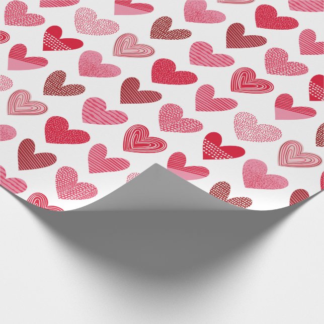 Cute hearts in pink and red on white wrapping paper (Corner)