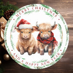 Cute Highland Cow Farm Animals Merry Christmas  Classic Round Sticker<br><div class="desc">Looking for the cutest Christmas cards of the season! Our Highland Cow duo featuring two holiday calves are sure to bring a smile to your loved ones' faces. The design is adorable with the calves wearing a Santa hat and a plaid winter scarf, surrounded by trees and a cosy winter...</div>