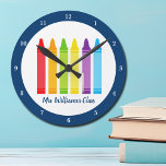 Cute Kindergarten Teacher Custom Crayon Classroom Round Clock<br><div class="desc">A beautiful Teacher Appreciation Week or End of Year gift for a kindergarten class to give to their elementary school teacher. Custom made clock with their name customised in blue. Personalise with your name or text under the cute rainbow of crayons. An adorable present for a preschool teacher.</div>