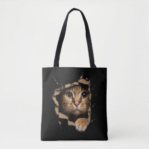 Cute kitten looks from torn fabric Cats Tote Bag