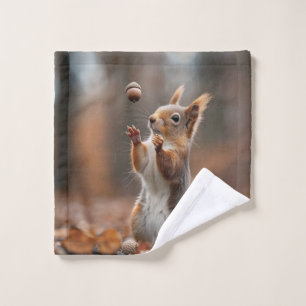 Cute little squirrel catching an acorn wash cloth