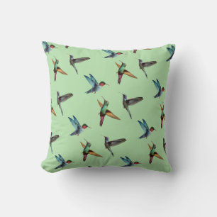 Cute multicolored hummingbirds on olive green cushion