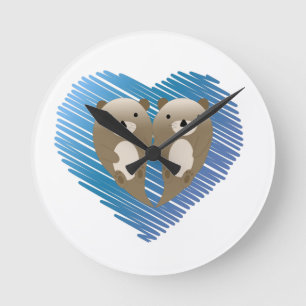 Cute Otters with Blue Heart in the Background Round Clock