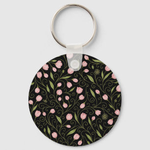 Cute, pink flower on black with repeating pattern key ring