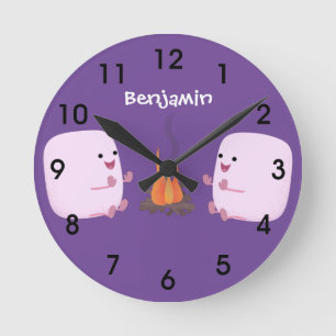 Cute pink marshmallows by camp fire cartoon round clock