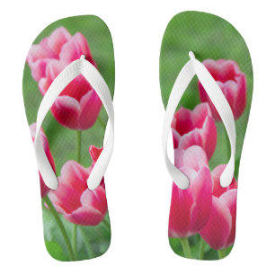 Cute scarlet tulips in the garden flip flops