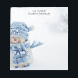 Cute Snowman in Winter Photograph Christmas Notepad<br><div class="desc">A notepad with a cute photograph of a little snowman. Standing outside in the winter with snow falling all around. This cute little guy is dressed up in blue knitted hat and scarf. Some white/gray bokeh flare in the background.</div>
