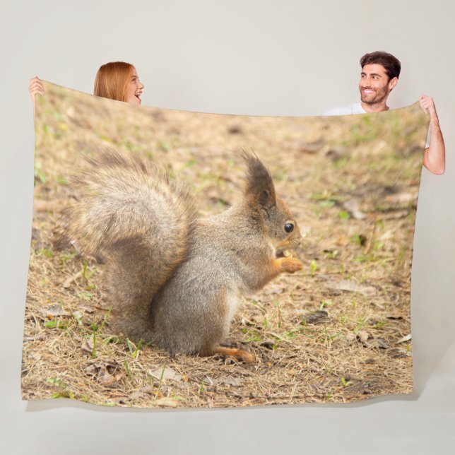 Cute squirrel eats a nut photo fleece blanket (In Situ)