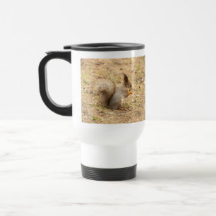 Cute squirrel eats a nut photo travel mug