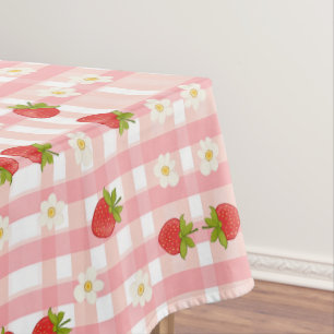 Cute strawberry and flowers on a pink gingham tablecloth